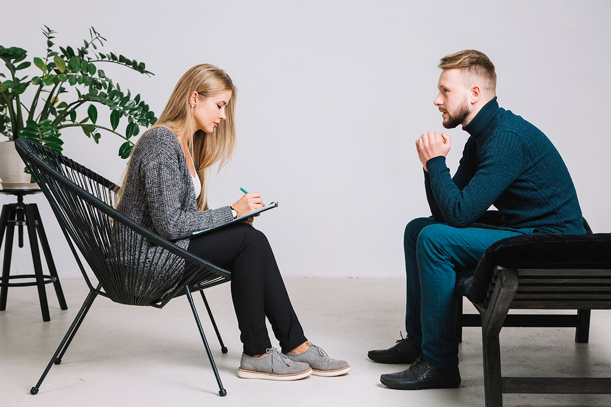 A kindfulness therapist in a calm, friendly counselling session with a client
